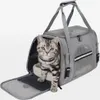 A cat is sitting inside a grey pet carrier bag. Náhľad obrázku produktu