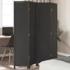 A dark gray room divider is shown in a bedroom setting, with a bed in the foreground and a desk with a laptop in the background. Podgląd zdjęcia produktu