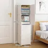 A white modular wardrobe unit filled with folded clothes and towels, placed next to a door and a bed. Anteprima dell’immagine prodotto