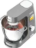 A close-up, angled studio shot of a gray stand mixer with a stainless steel bowl, mixing reddish batter. Produktbild-Vorschau