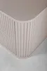 A close-up view of the corner of a beige cabinet with vertical ribbed detailing. Anteprima dell’immagine prodotto