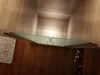 A shower door is shown in a bathroom setting with wooden walls and floor. Produktbild-Vorschau
