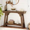 A wooden console table with decorative items in a room with white paneled walls. Podgląd zdjęcia produktu