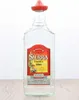 A bottle of Sierra Tequila Silver with a red sombrero cap, placed on a wooden surface against a white background. Náhľad obrázku produktu