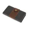 A closed wallet-style phone case with a snap closure, made of two-tone material. Produktbild-Vorschau