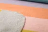 A close-up view of a colorful striped blanket. Produktbild-Vorschau