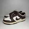 A pair of Nike Dunk Low Cacao Wow sneakers are displayed against a plain background. Náhled obrázku produktu