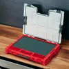 An open red tool case with a dark green foam insert sits on a wooden surface. Náhled obrázku produktu