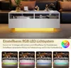 A white rectangular coffee table with LED lighting, shown in a living room setting with decorative items and a sofa in the background. The bottom section of the image displays four smaller images of the table with different colored LED lighting. Náhled obrázku produktu