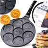 A collage of a smiley face pancake pan, cooked smiley face pancakes, and a stack of pancakes with blueberries. Náhled obrázku produktu