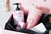A pink gift box containing beauty products and cups. Produktbild-Vorschau