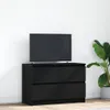 A black TV stand with a television on top, placed against a white wall with a potted plant to the right. Náhled obrázku produktu