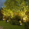 Garden spotlights illuminating bamboo plants at dusk. Produktbild-Vorschau