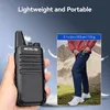 A hand holding a walkie-talkie next to a person putting a walkie-talkie in their pocket. Náhľad obrázku produktu