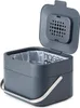 A dark gray compost bin with its lid open, showing a clear plastic liner inside. A silver handle is attached to the sides of the bin. Produktbild-Vorschau