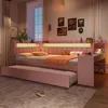 A pink bed with a pull-out trundle is set up in a bedroom with soft lighting and decorative items. Náhľad obrázku produktu