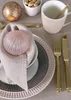 A table setting with plates, cutlery, a mug, and decorative items. Produktbild-Vorschau