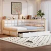 A corner daybed with storage drawers is set up in a bedroom with a rug and artwork on the wall. Náhled obrázku produktu