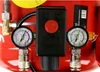 Close-up of an air compressor's control panel with two pressure gauges. Produktbild-Vorschau