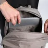 A person is placing a laptop into a backpack. Anteprima dell’immagine prodotto