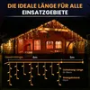 A wooden cabin decorated with icicle-shaped LED lights at night. Produktbild-Vorschau