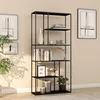 A black metal bookshelf filled with books, vases, and plants, placed against a light beige wall. Anteprima dell’immagine prodotto