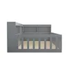 A side view of a gray wooden children's bed with a built-in bookshelf. Produktbild-Vorschau