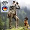 A man with binoculars and a dog in a natural outdoor setting. Anteprima dell’immagine prodotto
