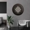 A dartboard mounted on a concrete wall in a modern room with a bed and a chair. Produktbild-Vorschau