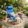 A blue beach chair is set up on a wooden deck in a garden setting, with plants and flowers around. Voir les images du produit