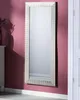 A full-length mirror with a silver frame hangs on a pink wall next to a white door. Náhľad obrázku produktu