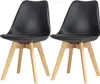 Two black dining chairs with wooden legs are shown against a white background. Náhled obrázku produktu