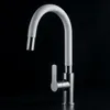 A close-up studio shot of a white and silver kitchen faucet against a black background. Produktbild-Vorschau