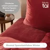 Close-up of red bedding with a text overlay. Voir les images du produit