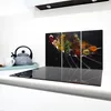 A kitchen scene with a glass stovetop protector featuring a triptych artwork of spices on spoons. Náhľad obrázku produktu
