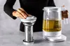 A person is using a tea kettle and infuser. Náhled obrázku produktu