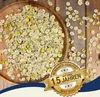 A wooden bowl filled with dried pea flakes on a wooden surface, with a marketing badge overlay. Produktbild-Vorschau