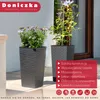Two tall, dark gray planters with plants in them, placed on a patio or outdoor steps. Náhled obrázku produktu