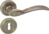 A bronze-colored door handle set with a round rosette, shown against a white background. Produktbild-Vorschau
