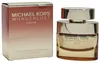 Michael Kors Wonderlust Sublime Eau de Parfum, 50 ml, in goldenem Glasflakon mit glänzender Verschlusskappe, daneben passende Farbverlauf-Verpackung. Podgląd zdjęcia produktu