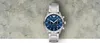 A silver Emporio Armani watch with a blue face is displayed against a textured gray and white background. Náhľad obrázku produktu