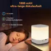 A child sleeping next to a glowing night light on a bedside table. Produktbild-Vorschau