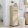 A bathroom scene with a wooden cabinet, a laundry basket, and a sink. Podgląd zdjęcia produktu