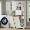 A white laundry storage cabinet with built-in laundry baskets and shelves filled with various products, next to a washing machine. Anteprima dell’immagine prodotto