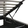 A close-up view of the internal mechanism of a bed frame, showing the hydraulic lift system and wooden slats. Náhled obrázku produktu