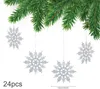 Silver glitter snowflakes hanging from a Christmas tree branch. Produktbild-Vorschau