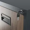 Close-up of a filing cabinet drawer with a key in the lock. Podgląd zdjęcia produktu
