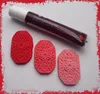 A tube of gel food coloring and three decorative elements made from dough or clay, colored in shades of red and pink. Náhled obrázku produktu