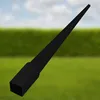 A black metal post anchor for pergolas or pavilions is shown against a blurred background of green grass and a blue sky with clouds. Produktbild-Vorschau