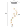 A multi-pendant chandelier with glass and crystal elements, shown with dimensions indicated. Podgląd zdjęcia produktu